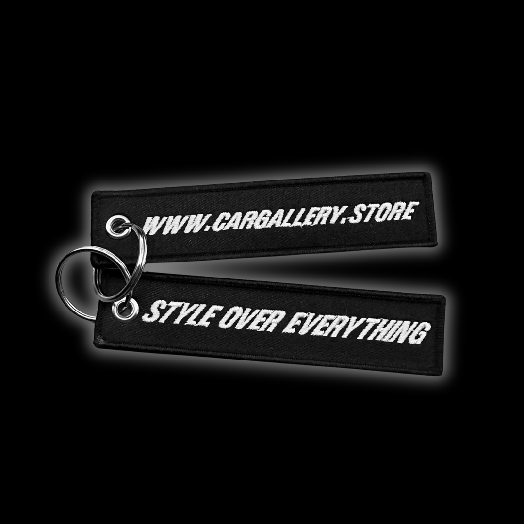 Custom Jet tag keychain with embroidered "Style over Everything", on black background