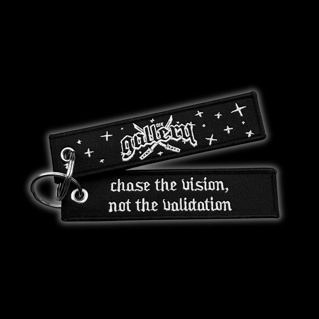 Custom Jet tag keychain with embroidered "Chase the vision, Not the validation", on black background