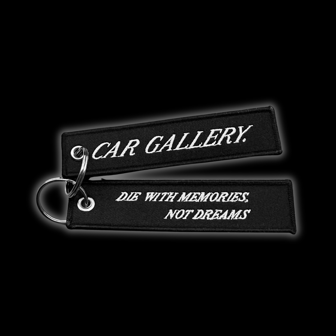 Custom Jet tag keychain with embroidered "Die with memories, Not dreams", on black background