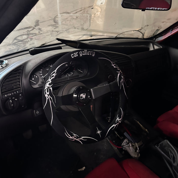 Custom racing Steering wheel made of Suede Leather with Embroidery decoration and 'car gallery' branding installed on a car
