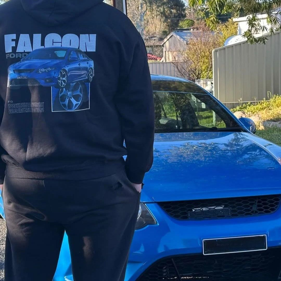 Customer wearing our custom car Hoodie featuring their Ford Faclon, photographed next to their car.