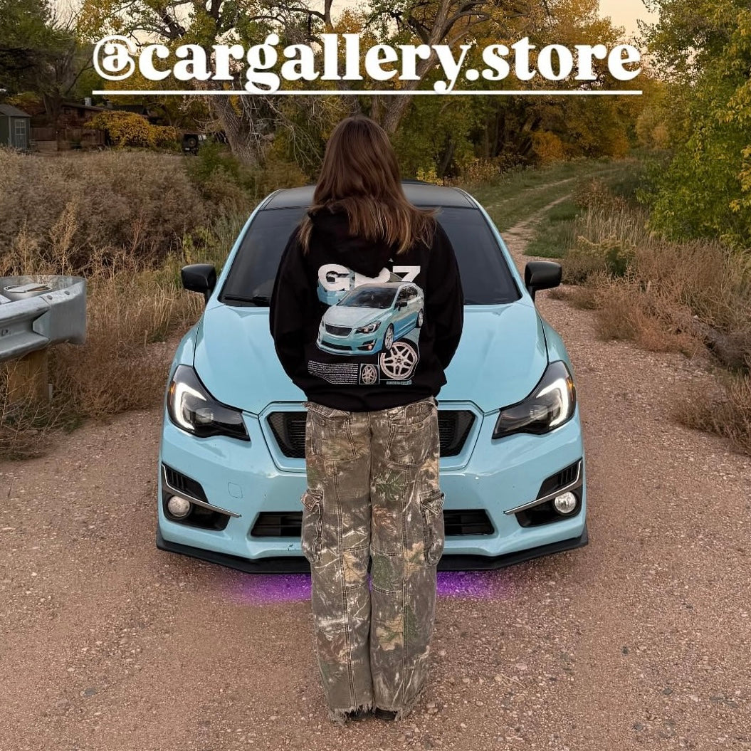 Customer wearing our custom car Hoodie featuring their Subaru Impreza, photographed next to their car.
