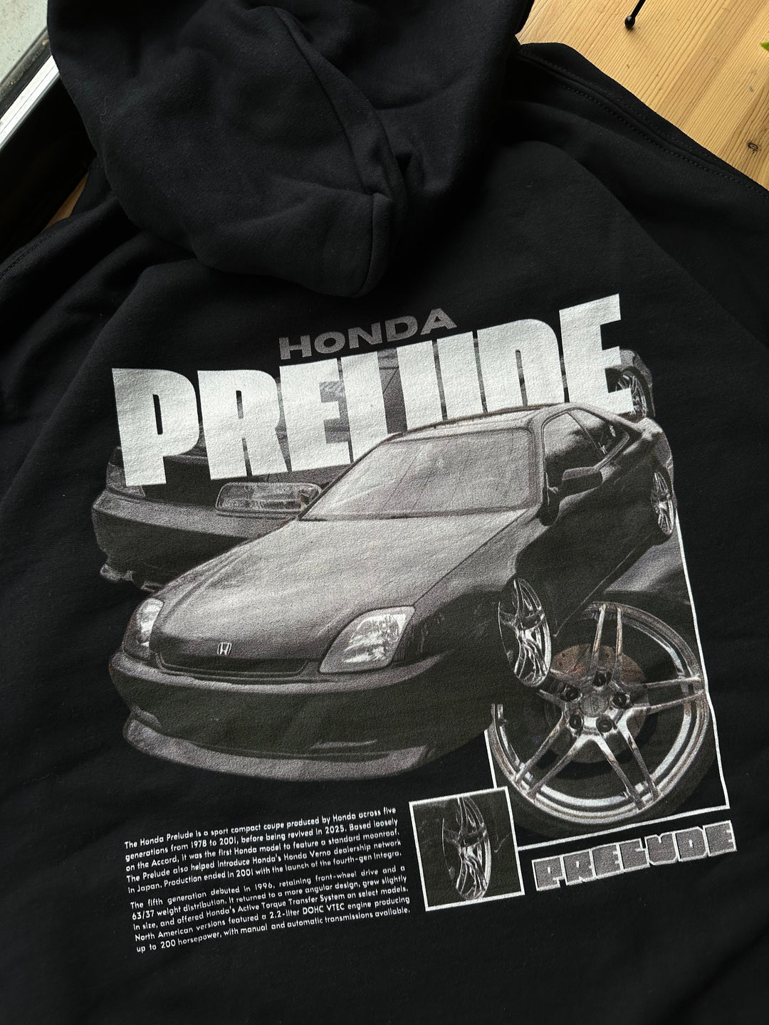Black hoodie with Honda Prelude BB9 graphic on the back, picture of the rear, closeup of graphic