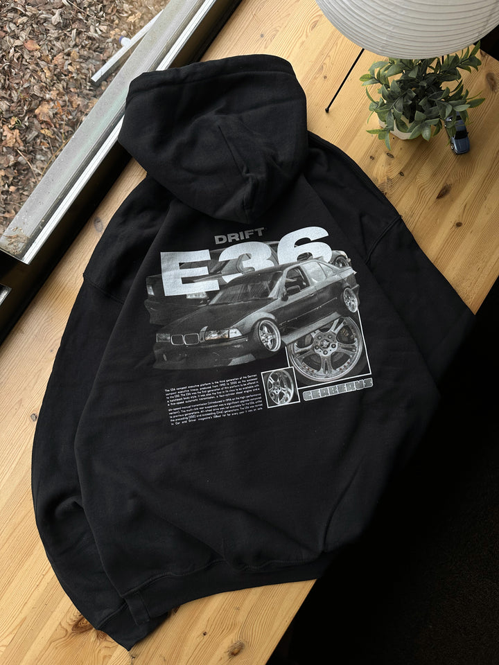 Black hoodie with Bmw E36 graphic on the back, picture of the rear, hoodie on desk