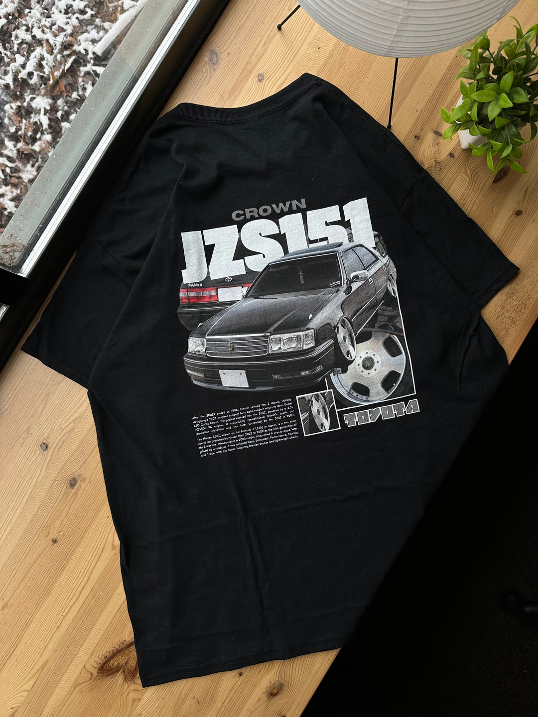 Black T-shirt with Toyota Crown JZS151 graphic on the back, picture of the rear, T-shirt on desk