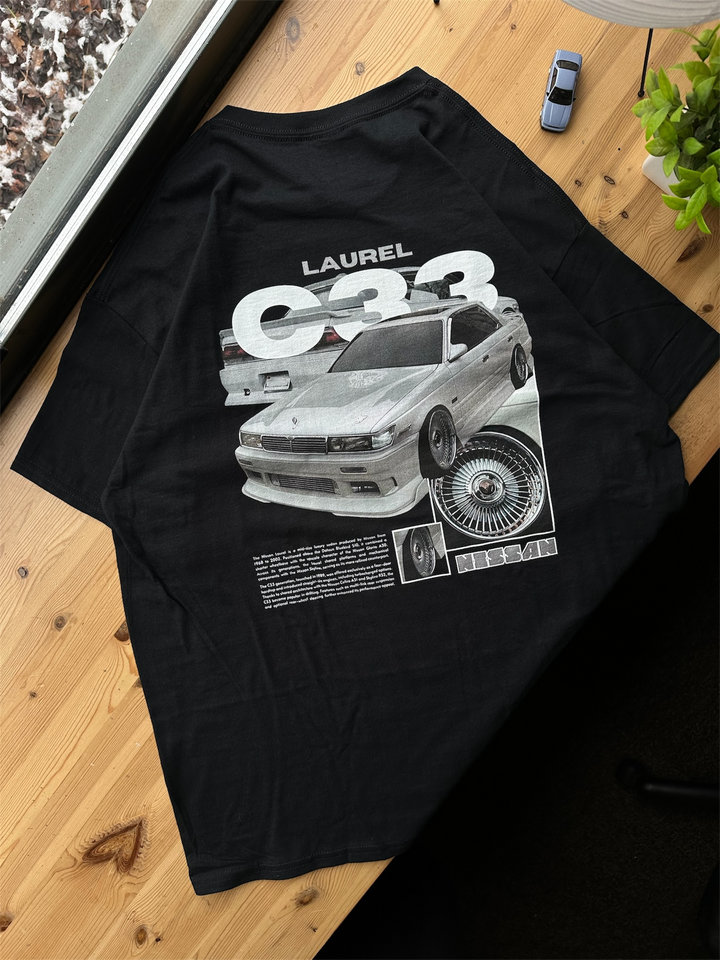 Black T-shirt with Nissan Laurel C33 graphic on the back, picture of the rear, T-shirt on desk