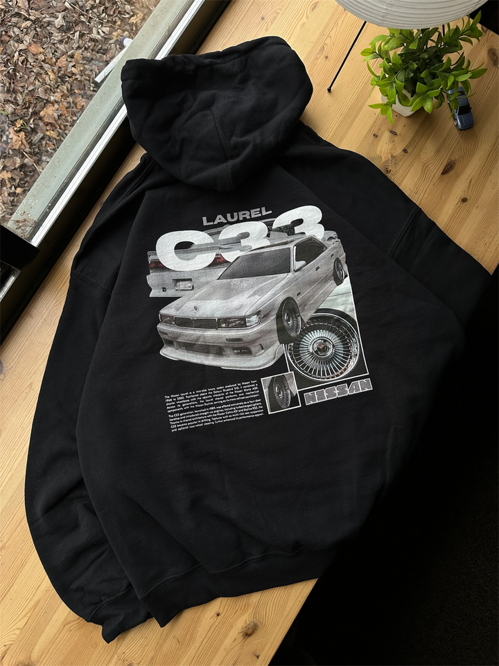 Black hoodie with Nissan Laurel C33 graphic on the back, picture of the rear, hoodie on desk 