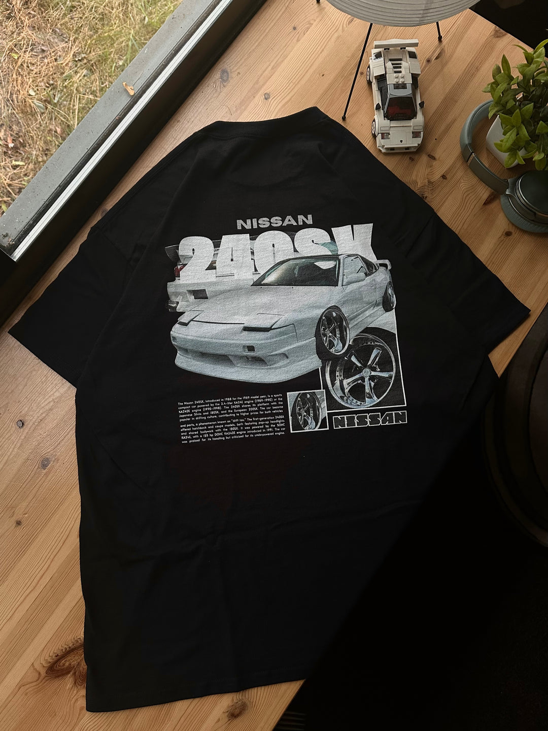 Black T-shirt with Nissan 240sx / 180sx / 200sx S13 graphic on the back, picture of the rear, T-shirt on desk